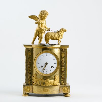 Pendule en bronze ciselé doré, surmontée d'un jeune enfant e…