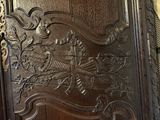 a wooden door that has a bird carved on it