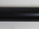 a black pipe that is on a white wall