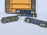 three toy trains sitting next to each other on a white surface