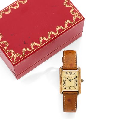 a red box with a gold watch and a red box with a gold watch on it