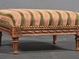 a small foot stool with a striped upholstered seat
