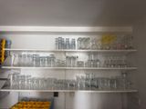 many empty glasses on the shelves in the kitchen