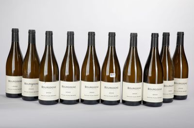 six bottles of wine are lined up in a row on a table