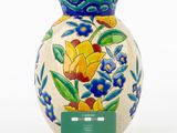 a vase with a tag on it sitting on a table