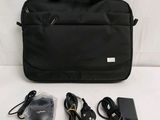 a black bag with a laptop and a charger on it
