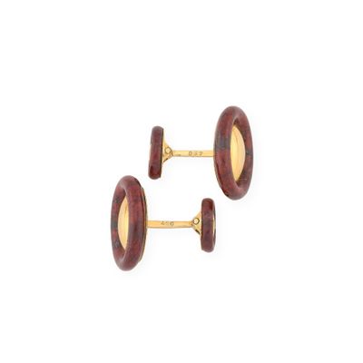 two pairs of red and gold cufflinks on a white background