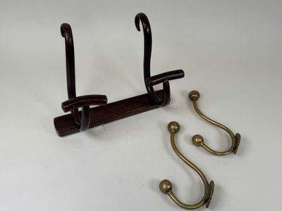 two hooks that are attached to a coat rack