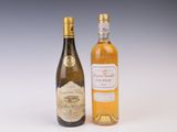 two bottles of wine sitting next to each other on a white surface