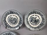 four black and white plates with a picture of a man and a woman on them