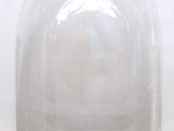 a glass dome with a wooden base on a white surface