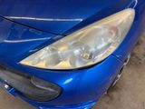 a close up of a blue car that is parked in a garage