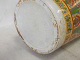 a close up of a vase on a white surface