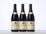 three bottles of wine sitting on top of a table