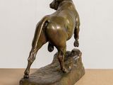 bronze statue of a bull on a rock on a table