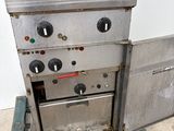 a metal oven sitting on top of a pallet