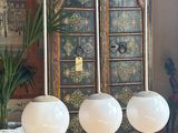 three globes on top of a cabinet in a living room