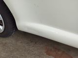 a close up of a white car with a flat tire