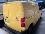a yellow van that is parked in a parking lot