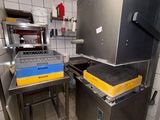 a kitchen with a stove, sink, and oven in it