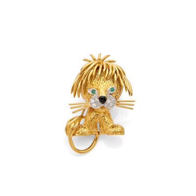 a gold and diamond lion broochle with green eyes