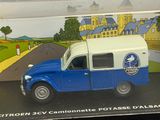 a blue and white toy truck in a clear box