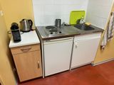 a small kitchen with a sink and a dishwasher in it