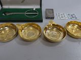 four gold plated bowls and spoons in a green box