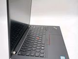 a black laptop with a red button on the keyboard