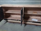 a wooden cabinet with two doors open in a warehouse