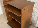 an image of a small wooden book shelf in a room