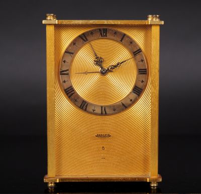 an image of a gold clock with roman numerals on the face