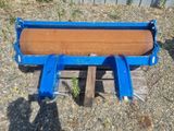 a blue machine that is sitting on a wooden pallet