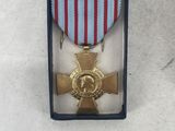 a medal in a box with a ribbon around it