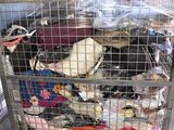 a metal cart with many items in it in a warehouse