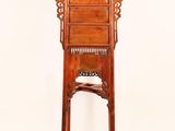 an old wooden chair with a carved back and legs