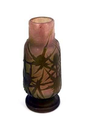 a vase that is sitting on a stand on a white surface