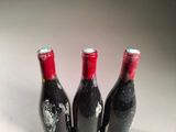 three bottles of wine that are sitting on a table