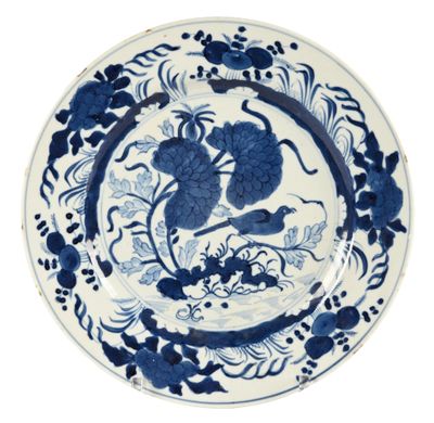 blue and white plate with a bird and flowers on it