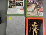three video games sitting on a table next to a mouse