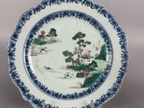 an image of a blue and white plate with a landscape on it