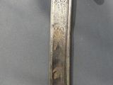 two swords are displayed on a table in a display case