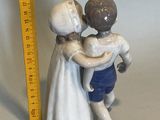 a figurine of a boy and a girl hugging each other