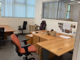 an image of an office with a desk and chairs
