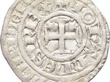 a close up of a coin with a cross on it