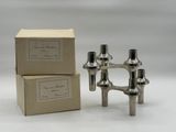 two silver candles are sitting next to each other in a box