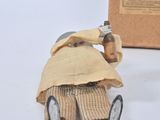 a figurine of a man sitting on the ground next to a box