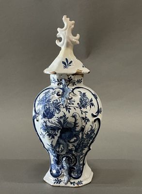 a blue and white vase with a bird on it