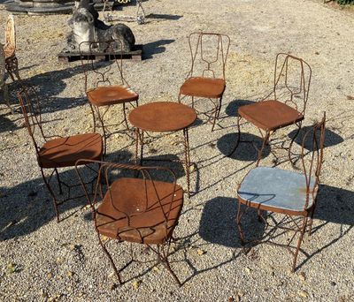 a lot of chairs and tables that are sitting in the dirt