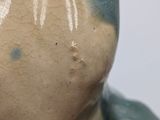 a close up of a ceramic figurine of a man